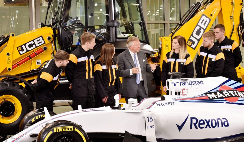 JCB Chairman Lord Bamford pictured with JCB apprentices (l-r) Kyle Hare , Charlie Trotter, Jade Holmes, Chelsea Saunders, Daniel Malbon and James Mohan at the announcement of the new partnership agreement between JCB and Williams Martini Racing.