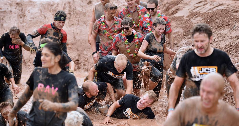 A record-breaking - and capacity - field of 3,000 squirmed and splashed their way to a £70,042 charity total by taking on the challenge of the 6th annual JCB Mud Run.