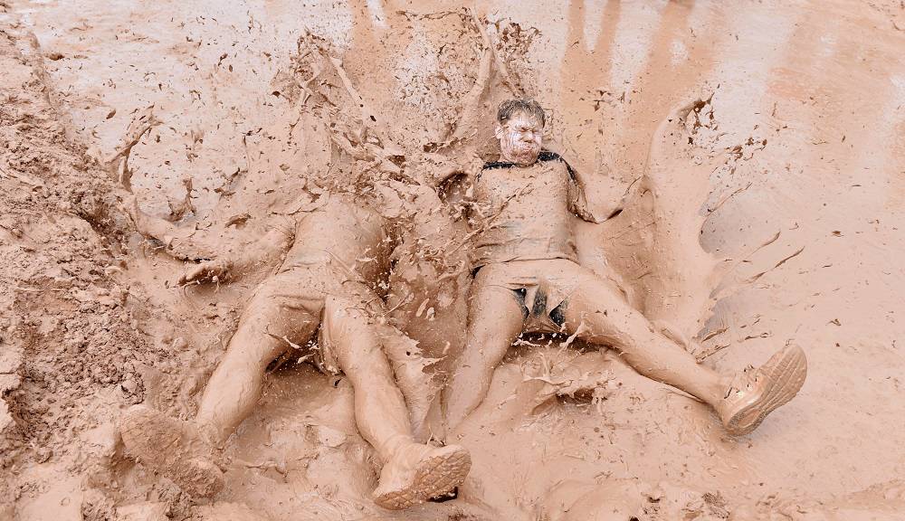 A record-breaking - and capacity - field of 3,000 squirmed and splashed their way to a £70,042 charity total by taking on the challenge of the 6th annual JCB Mud Run.