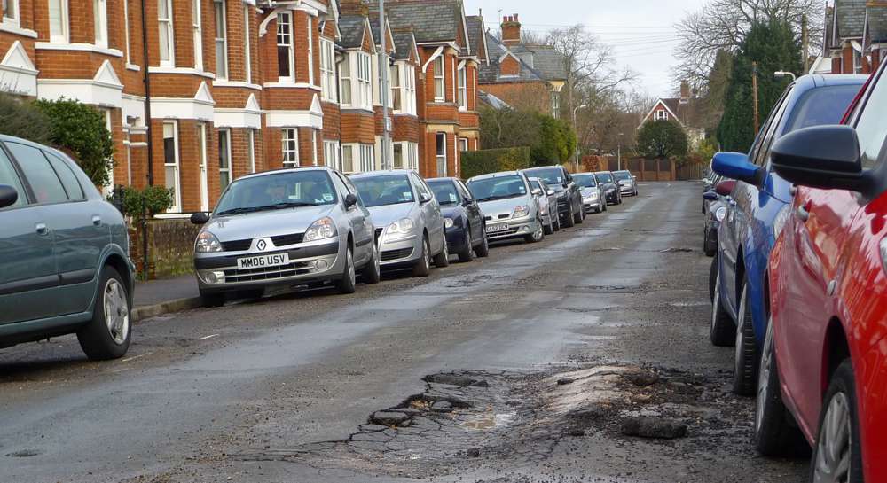 Pothole in the road - Photo by Henry Burrows