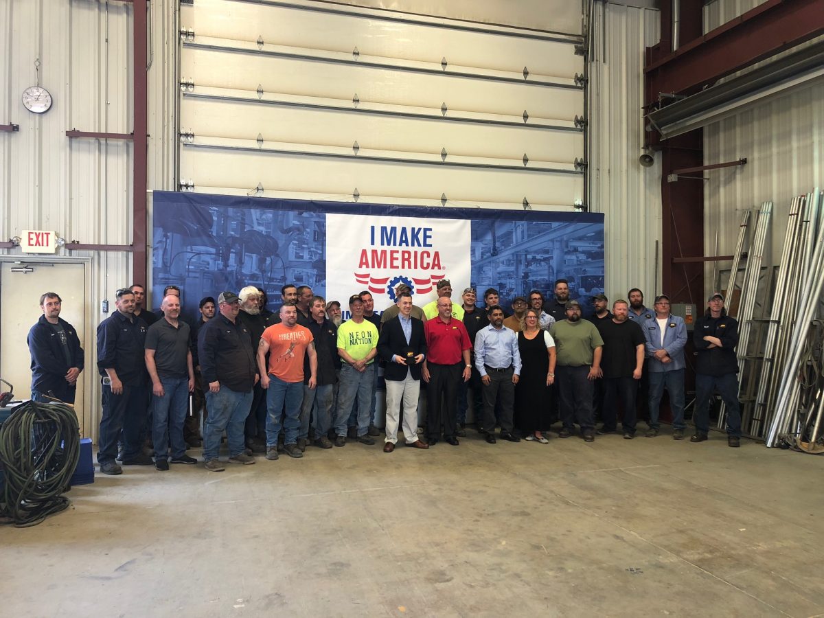 U.S. Representative Jim Banks poses for a group photo with employees at Asphalt Drum Mixers’ facility in Huntertown, Indiana. ADM invited the congressman through the AEM “I Make America” program. Image courtesy of Asphalt Drum Mixers