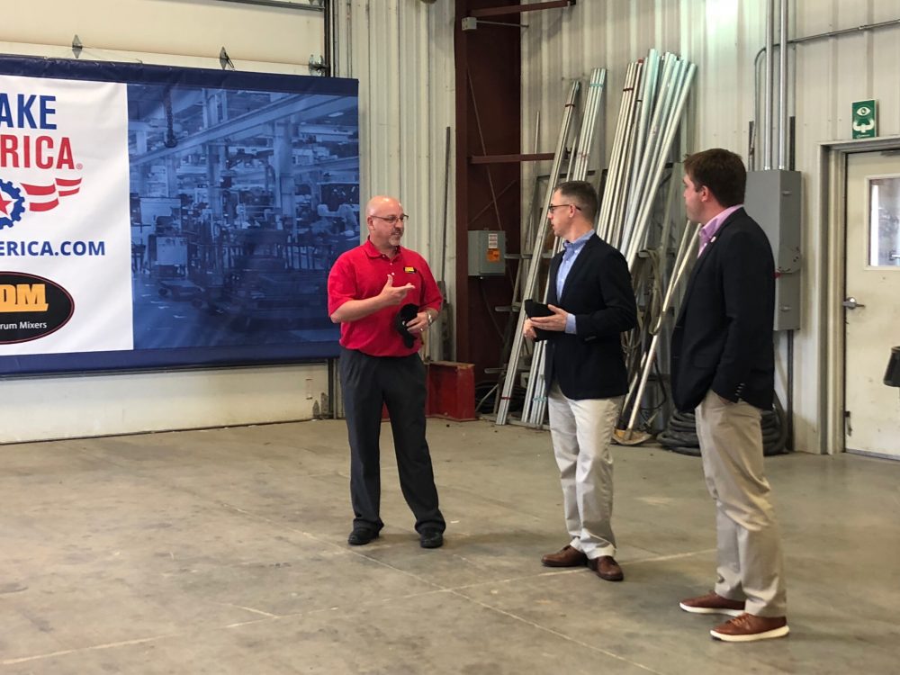 U.S. Representative Jim Banks (middle) speaks with Asphalt Drum Mixers President Mike Devine (left) and AEM Vice President, Public Affairs & Advocacy Kip Eideberg (right) about topics important to the manufacturing industry. Image courtesy of Asphalt Drum Mixers