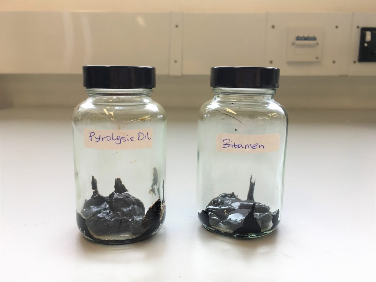 Jars showing the visual similarity between traditional bitumen (right) and bio-bitumen (left)