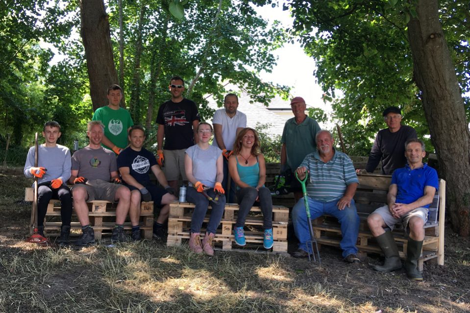 The Highways England team, including assistant project manager Karl Sullivan fourth left, and Chacewater villagers, with Rob Knill third from right, and the team busy clearing vegetation