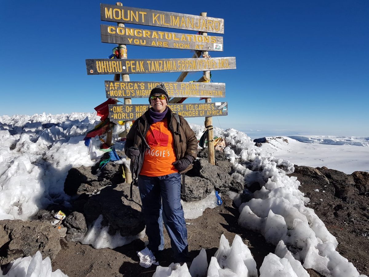 Tina at the Summit of Kilimanjaro in her Maggie's T Shirt