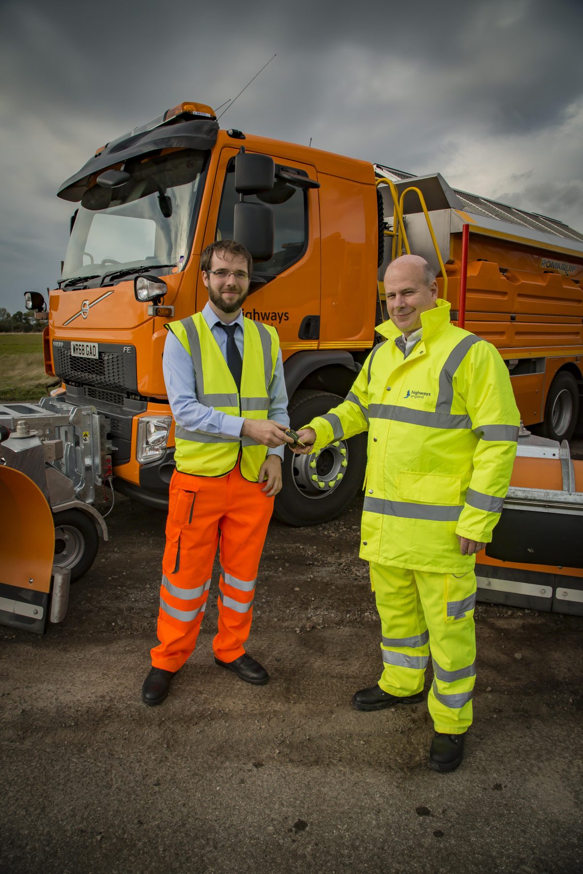 Stephen McKeown hands over the keys to Nick Harris, Highways England's executive director of operations