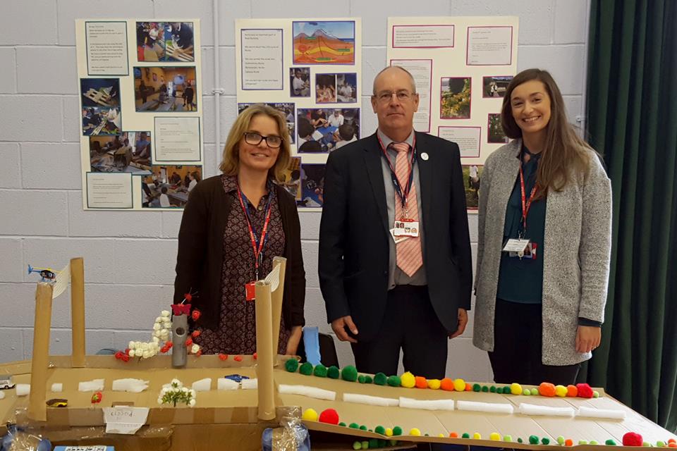 Minety School teacher Maria Madeley, left, with Garry Packer and Emma Grayson of Highways England and her pupils' bridge design at the British Science Association's How Real Stuff Works event at Malmesbury School