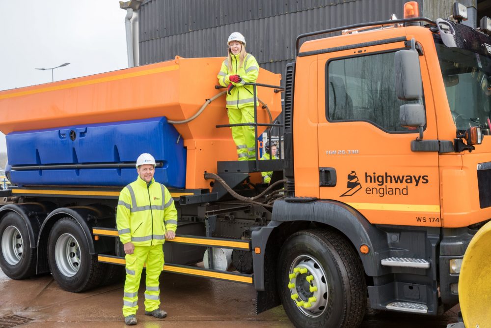 Karen and Neil next to one of the gritting machines being used to keep motorways moving this winter